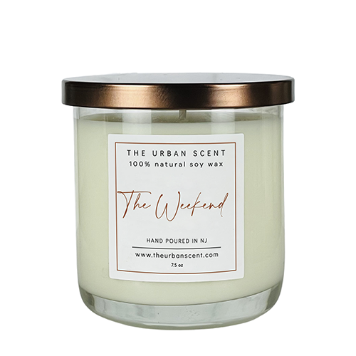 The Weekend soy candle with black pepper, lavender, and warm amber woods in a cozy modern jar.