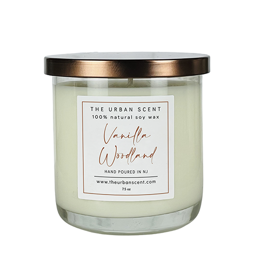 Vanilla Woodland soy candle with white birch, vanilla, and sandalwood in a glass jar.